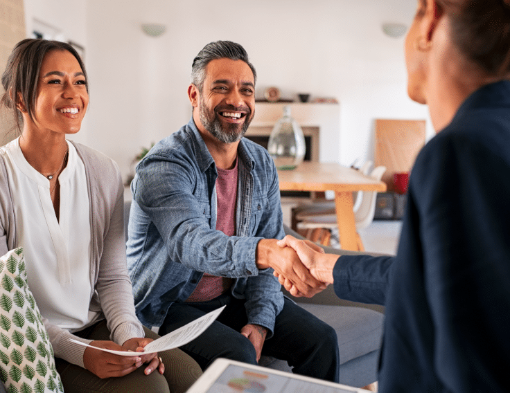 Parents shake the hand of an administrator