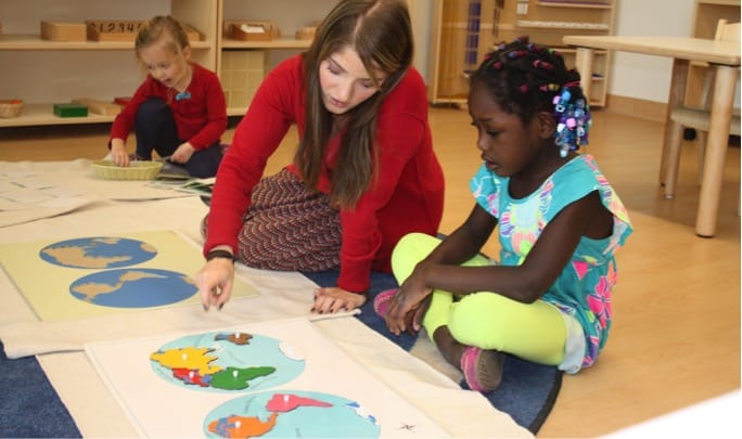 Teacher discussing world map with student