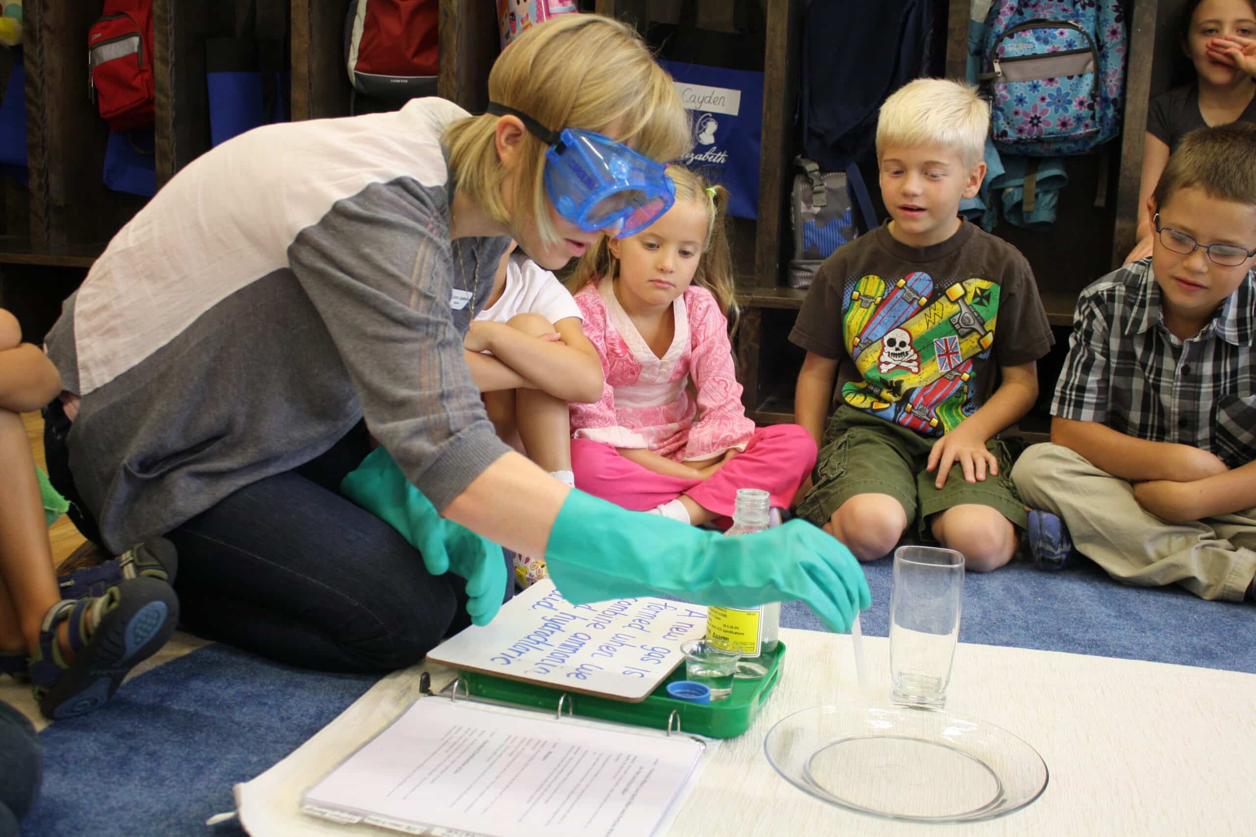 Teacher does science project with group of children