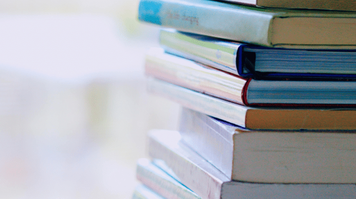 Stack of books on opaque background