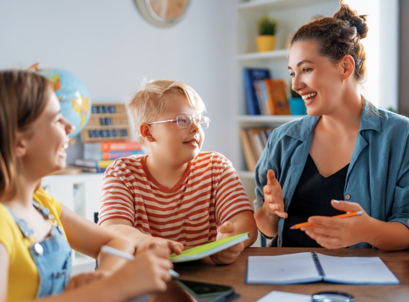 Teacher works with two students