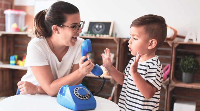 Teacher and Toddler play with toy phone