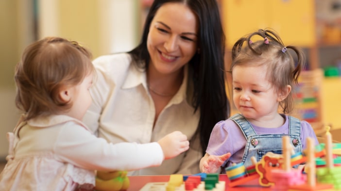 Teacher teaching two toddlers